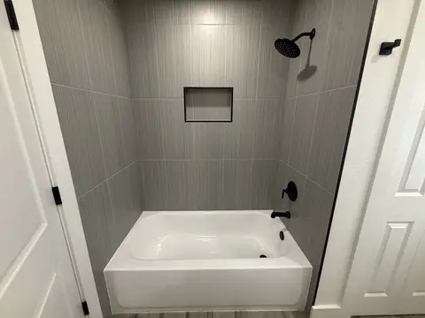 Bathroom remodel with tiled tub surround