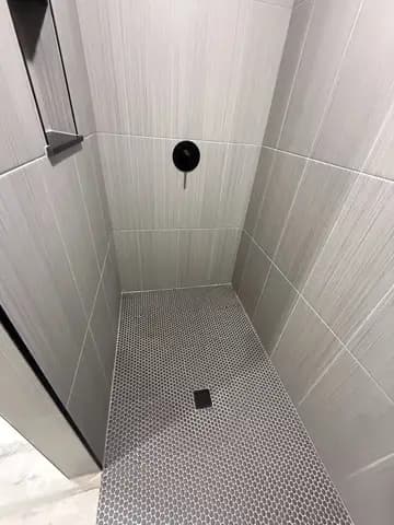 Walk-in shower tile installation during bathroom remodel
