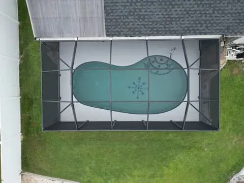 Top-down drone view of a pool cage installation