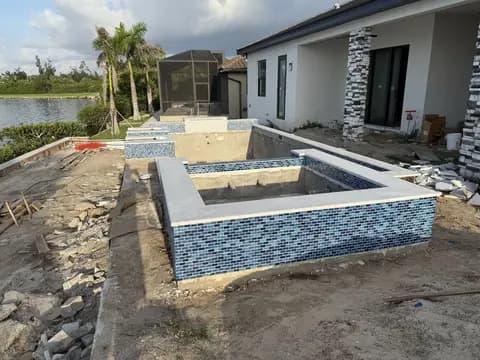 Waterfront pool construction with spa framing in progress