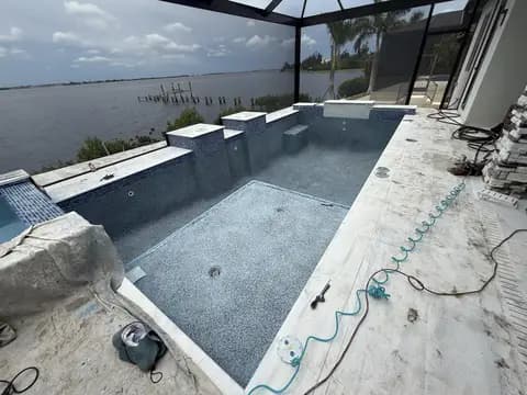 Pool remodel with dark tile finish