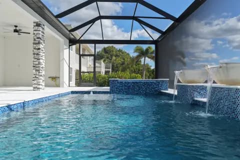 Finished waterfront pool and raised spa by Vertical Builders and Commercial
