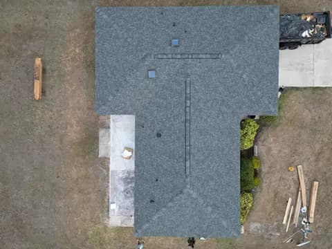 Top-down drone view of a completed shingle roof replacement