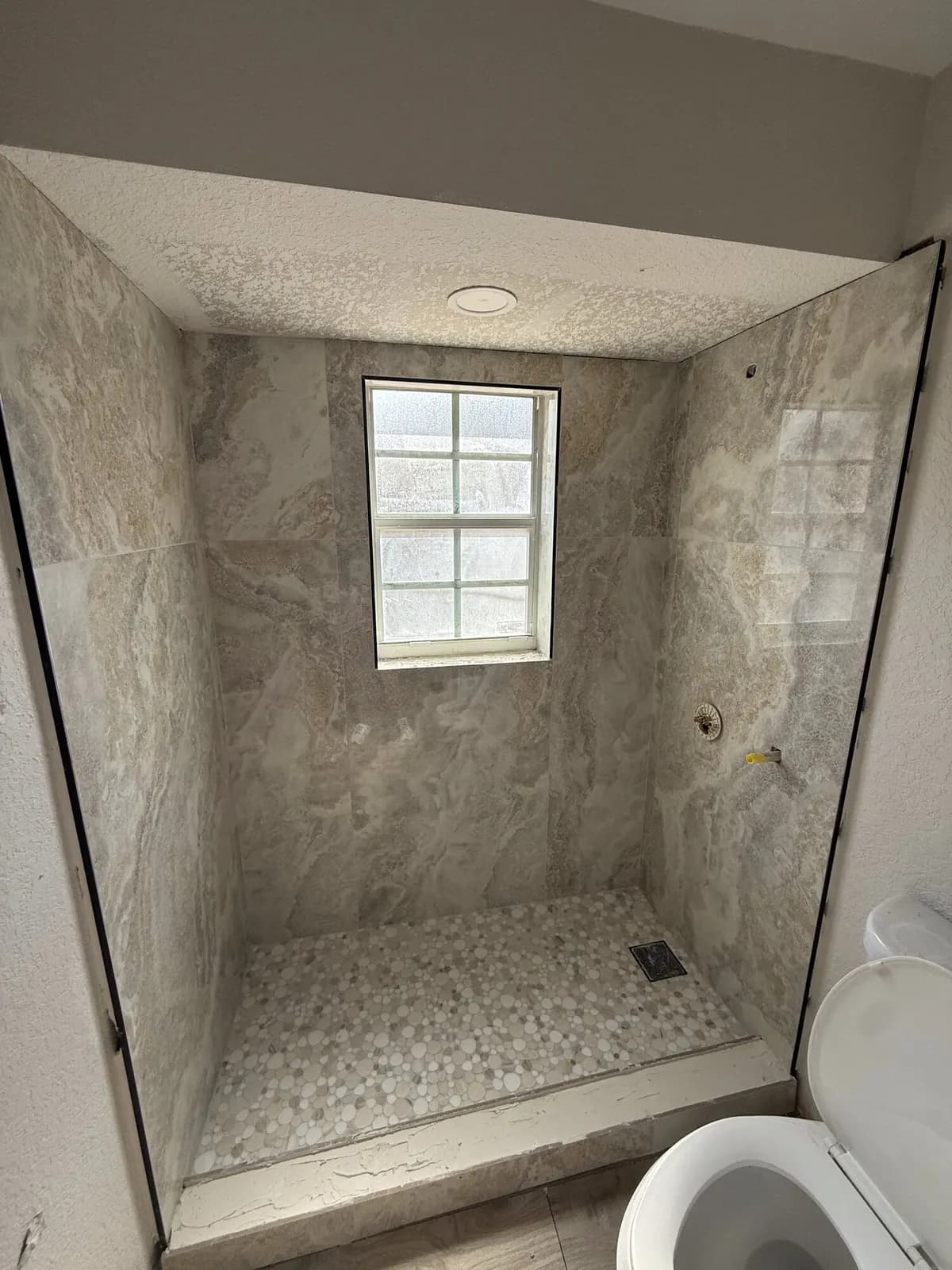 Custom tiled walk-in shower with niche
